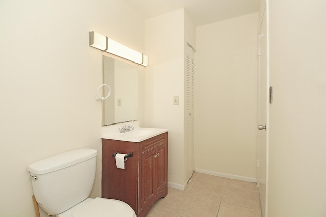 bathroom featuring toilet, tile flooring, and oversized vanity