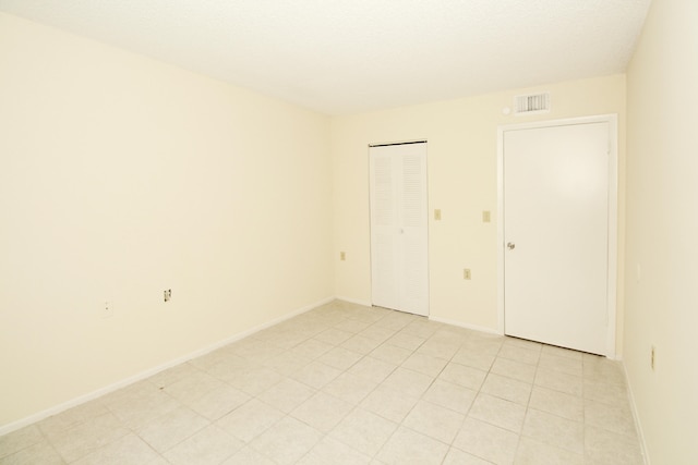 unfurnished room with light tile floors