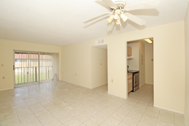 unfurnished room with light tile floors, a textured ceiling, and ceiling fan