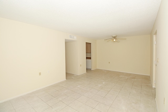 tiled empty room with a textured ceiling and ceiling fan