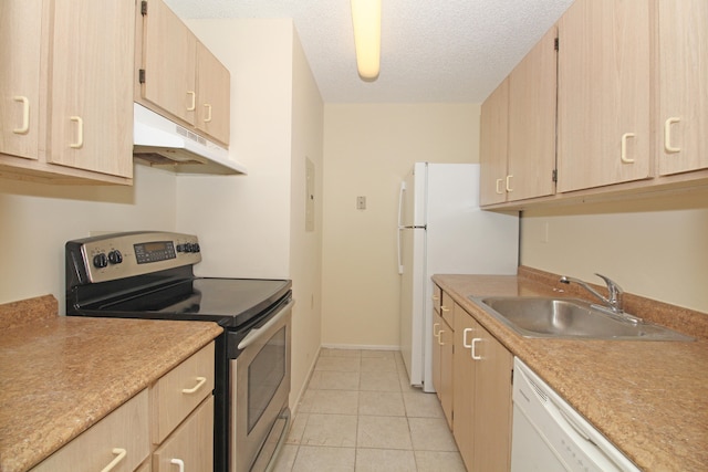 kitchen featuring white appliances, sink, light tile floors, light brown cabinets, and a textured ceiling