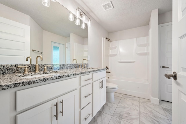 full bathroom featuring vanity, a textured ceiling, toilet, and shower / bathtub combination