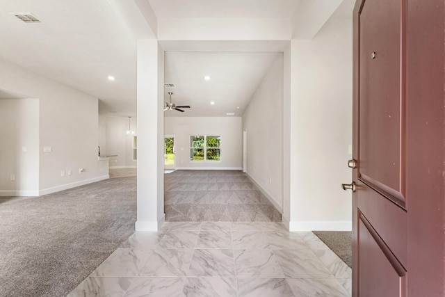 foyer with light colored carpet and ceiling fan