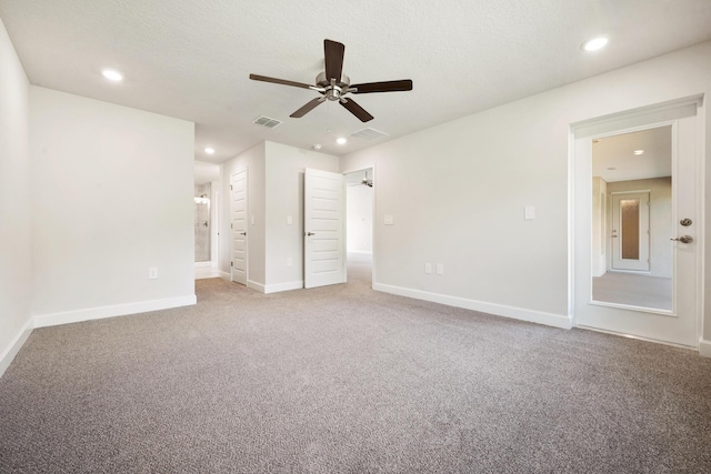 unfurnished bedroom with ceiling fan, carpet floors, and a textured ceiling