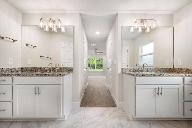 bathroom with ceiling fan, a healthy amount of sunlight, and vanity