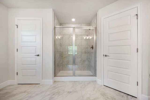 bathroom with a textured ceiling and walk in shower