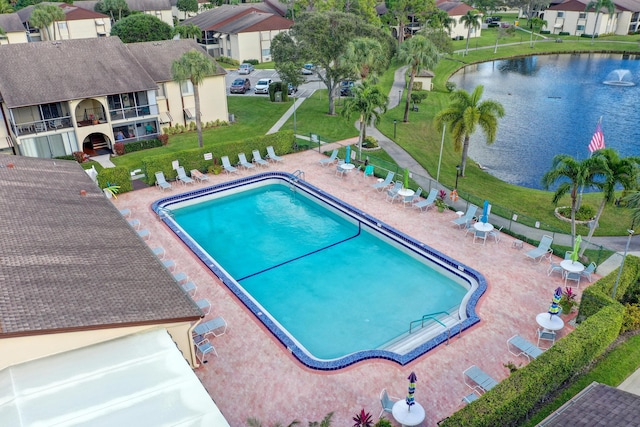 view of pool featuring a water view and a patio area