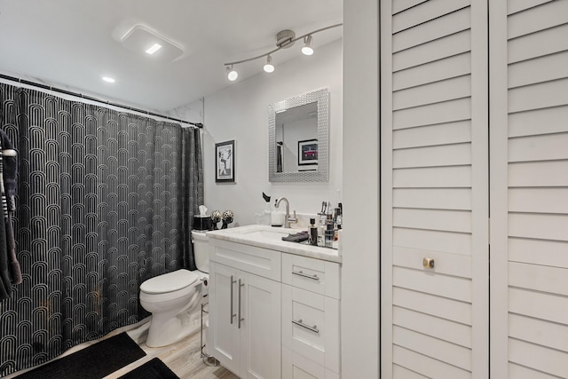 bathroom featuring hardwood / wood-style floors, vanity, and toilet