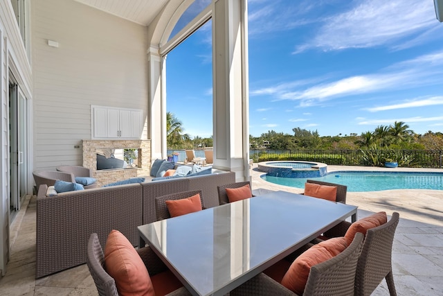 exterior space with an in ground hot tub, an outdoor living space with a fireplace, and a patio area