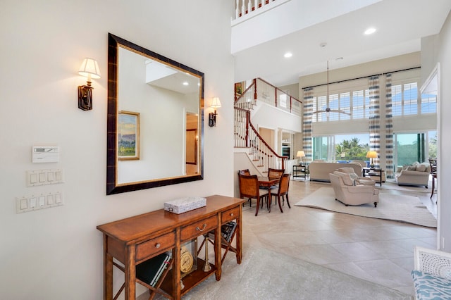 interior space featuring light tile floors and a high ceiling