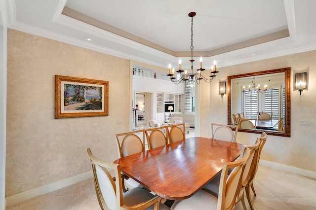 tiled dining room with a raised ceiling, a notable chandelier, and crown molding