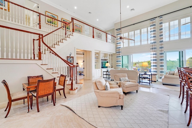 living room with light tile flooring, a high ceiling, and ceiling fan