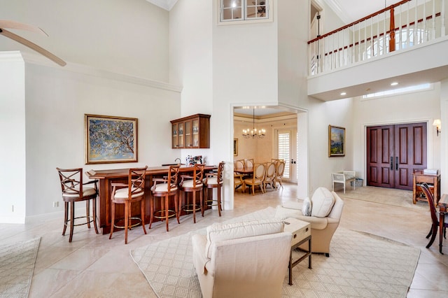 tiled living room with an inviting chandelier and a towering ceiling