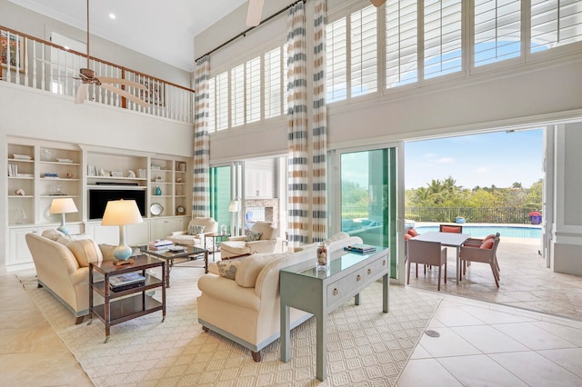 tiled living room featuring a towering ceiling and built in shelves