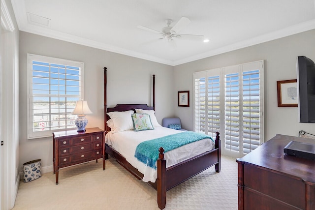 carpeted bedroom featuring crown molding, ceiling fan, and multiple windows