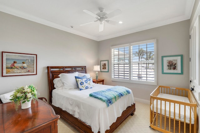 bedroom featuring crown molding, ceiling fan, and light carpet