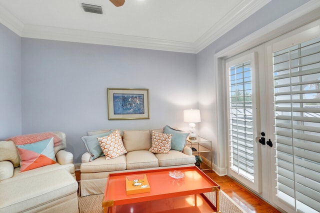 living room with crown molding, french doors, ceiling fan, and light hardwood / wood-style flooring