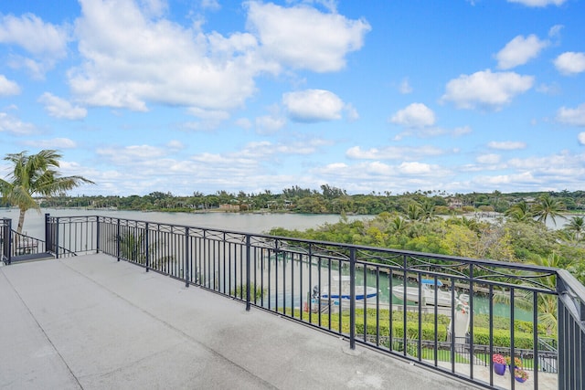 view of patio / terrace featuring a balcony and a water view