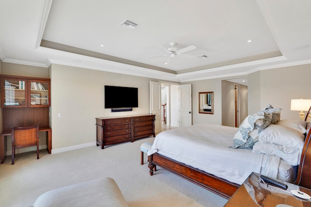 bedroom with ceiling fan, crown molding, a raised ceiling, and light colored carpet