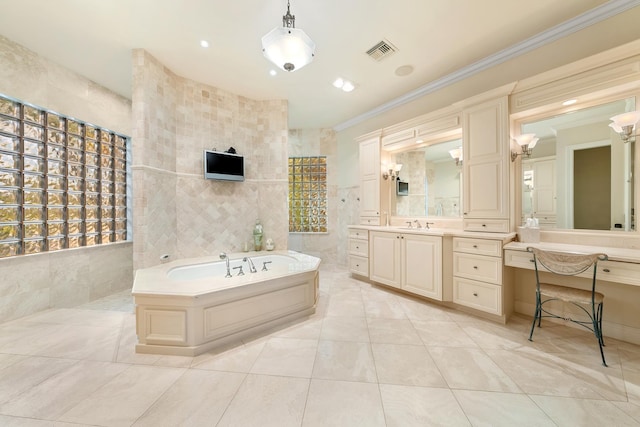 bathroom with tile walls, tile patterned flooring, vanity, ornamental molding, and a tub