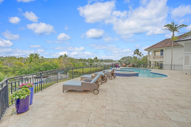 view of pool featuring an in ground hot tub and a patio area