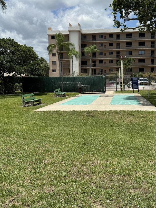 view of pool featuring a lawn