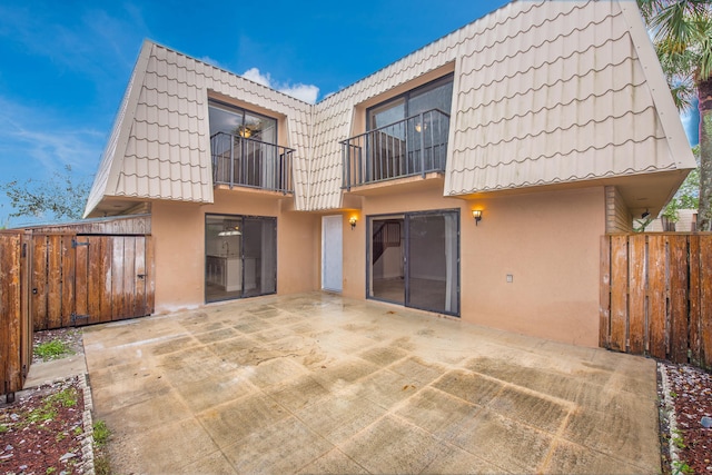 back of house with a balcony and a patio area