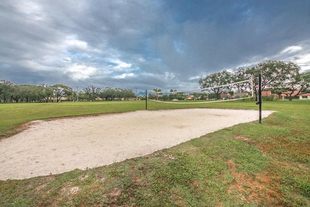 surrounding community featuring volleyball court and a yard