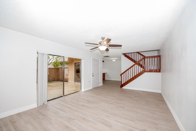 unfurnished living room with a textured ceiling, ceiling fan, and light hardwood / wood-style flooring