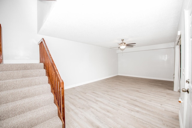 empty room featuring ceiling fan and light hardwood / wood-style flooring