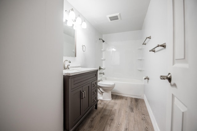 full bathroom with toilet, washtub / shower combination, large vanity, and wood-type flooring