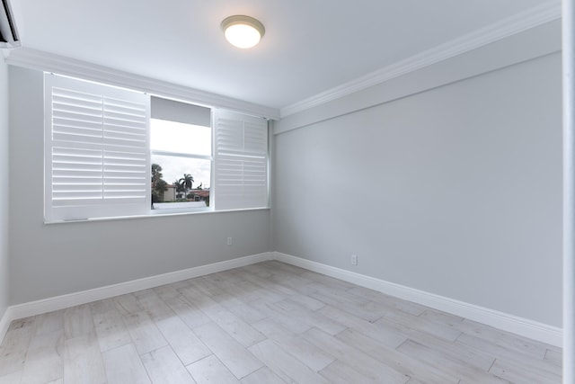 unfurnished room featuring light hardwood / wood-style floors and ornamental molding