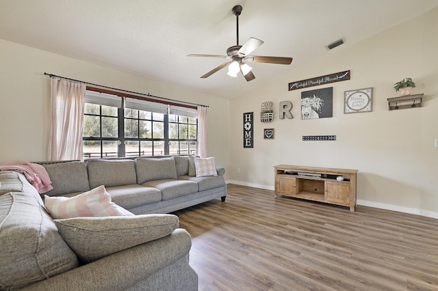 living room featuring wood-type flooring and ceiling fan