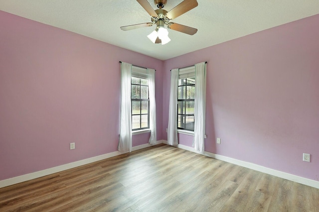 empty room with ceiling fan and light wood-type flooring