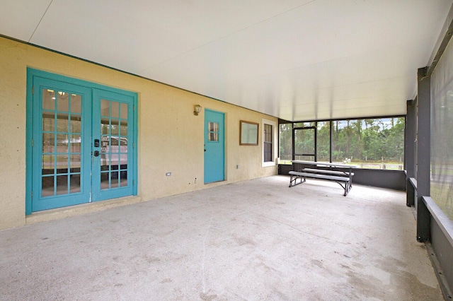 unfurnished sunroom featuring french doors