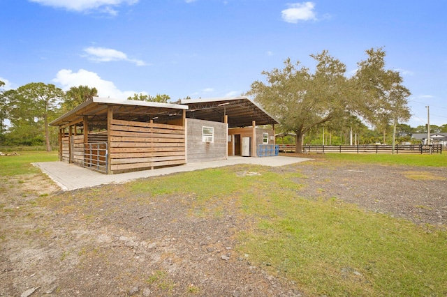 view of horse barn featuring a rural view