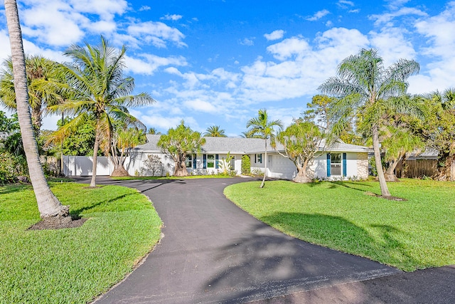 single story home with a garage and a front lawn