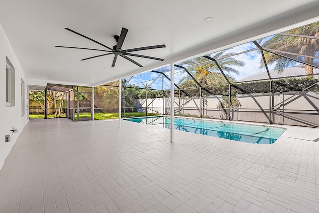 view of pool with a patio, ceiling fan, an outdoor structure, and a lanai