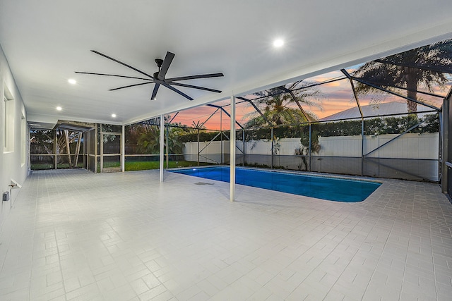 pool at dusk featuring a patio and ceiling fan