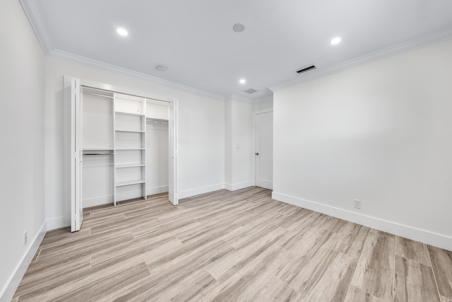 unfurnished bedroom with light wood-type flooring, a closet, and ornamental molding