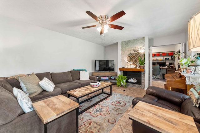 living room with a large fireplace and ceiling fan