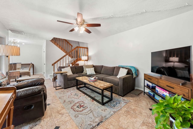 living room featuring a textured ceiling, ceiling fan, and light tile flooring