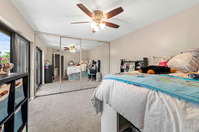 carpeted bedroom with a closet and ceiling fan