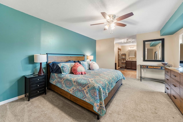 carpeted bedroom with connected bathroom and ceiling fan