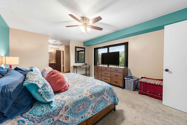 carpeted bedroom with ceiling fan and a textured ceiling