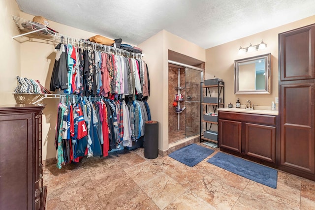 walk in closet with light tile floors