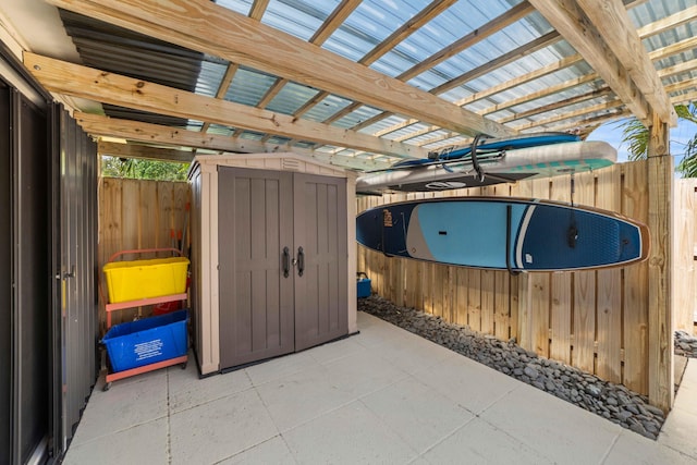 view of terrace with a shed and a pergola