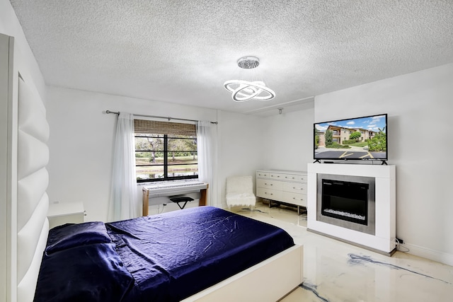 bedroom featuring a chandelier and a textured ceiling