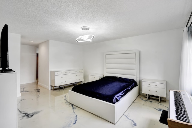 bedroom with an inviting chandelier and a textured ceiling