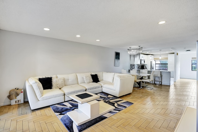 living room with light parquet floors and a textured ceiling